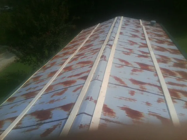 Rusted metal roof panels with new wood purlins before replacement — Storm Damage Roof Repair in Hickory by Roofing Brothers