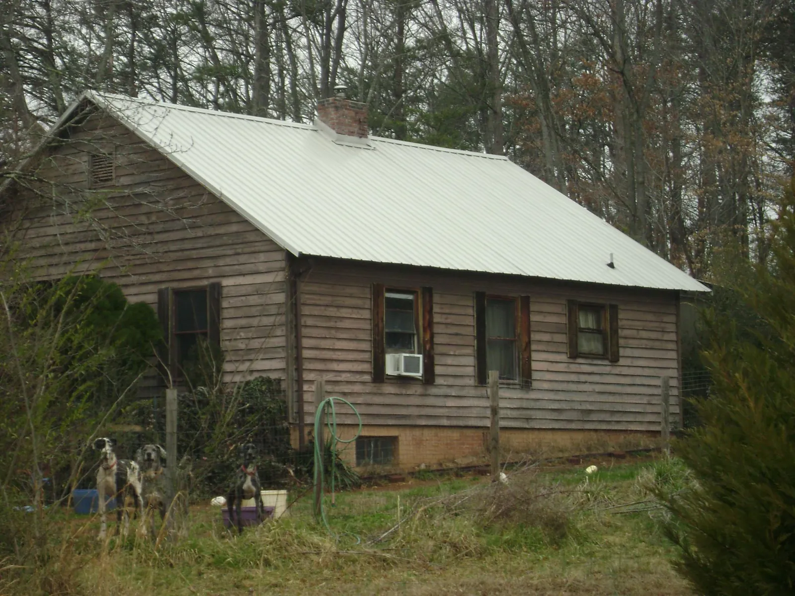 White metal roof on an old wood sided farmhouse, from a Asphalt Shingle Roof Repair job in Hickory